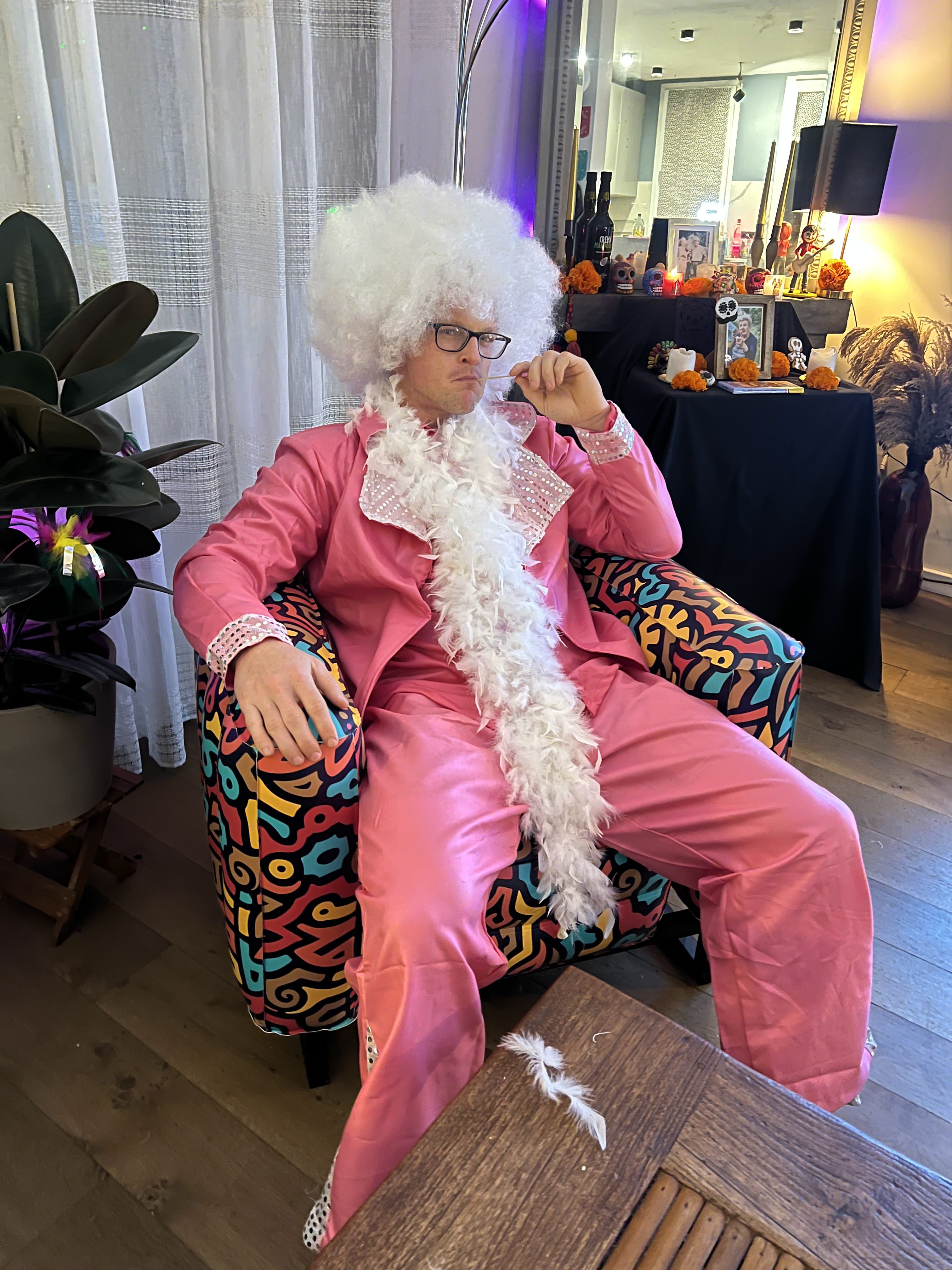 Man with a wig and pink suit on